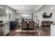 Dining room featuring stylish chairs, wood table, and hardwood floors next to the kitchen at 3134 S Fairplay St, Aurora, CO 80014