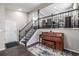 Inviting entryway featuring hardwood floors, a piano, and staircase leading to the upper level at 3134 S Fairplay St, Aurora, CO 80014