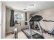 Home gym features an exercise bike, treadmill, and weight lifting station at 3134 S Fairplay St, Aurora, CO 80014