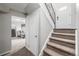 Hallway with carpeted stairs leading to a lower level living room at 3134 S Fairplay St, Aurora, CO 80014