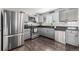 Well-lit kitchen with stainless steel appliances and dark wood flooring at 3134 S Fairplay St, Aurora, CO 80014