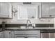 Kitchen with stainless steel sink and modern appliances, including a dishwasher at 3134 S Fairplay St, Aurora, CO 80014