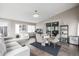 Spacious living room area with hardwood floors, large windows, and sliding door access at 3134 S Fairplay St, Aurora, CO 80014