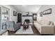 Cozy living room with a brick fireplace, hardwood floors, and comfortable seating at 3134 S Fairplay St, Aurora, CO 80014