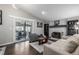 Bright living room with hardwood floors, brick fireplace, and access to the backyard at 3134 S Fairplay St, Aurora, CO 80014