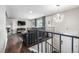Cozy living room with modern lighting and hardwood floors, accessed by stairs at 3134 S Fairplay St, Aurora, CO 80014