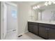 Spacious bathroom featuring dual sinks, tile flooring and modern vanity at 7241 Goldbloom Ln, Littleton, CO 80125