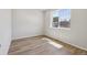 Bright bedroom with hardwood floors and a large window offering plenty of natural light at 7241 Goldbloom Ln, Littleton, CO 80125