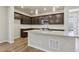 Modern kitchen featuring stainless steel appliances, a center island, and stylish pendant lighting at 7241 Goldbloom Ln, Littleton, CO 80125