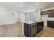Open concept kitchen with stainless appliances, large island and hardwood flooring at 7241 Goldbloom Ln, Littleton, CO 80125