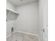Functional laundry room with tile flooring and space for washer and dryer at 7241 Goldbloom Ln, Littleton, CO 80125