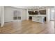 Open-concept living area featuring hardwood floors, abundant natural light, and a modern kitchen at 7241 Goldbloom Ln, Littleton, CO 80125
