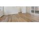 Open-concept living room with wood-look flooring, neutral paint, and lots of natural light at 7241 Goldbloom Ln, Littleton, CO 80125