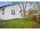 A spacious backyard with a grassy lawn and a deck for relaxing and entertaining at 22 S Harlan St, Lakewood, CO 80226