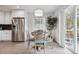 Bright dining area featuring a stainless steel refrigerator and a view of the outdoor patio at 22 S Harlan St, Lakewood, CO 80226