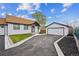 Charming home with a detached garage, new asphalt driveway, green grass, and a well-maintained landscape at 22 S Harlan St, Lakewood, CO 80226