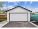 A detached two-car garage has white siding and a large white garage door at 22 S Harlan St, Lakewood, CO 80226