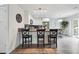 Open-concept kitchen with a breakfast bar, offering a seamless flow between cooking and dining spaces at 22 S Harlan St, Lakewood, CO 80226