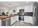 Efficient kitchen featuring modern appliances, ample countertop space, and stylish backsplash at 22 S Harlan St, Lakewood, CO 80226