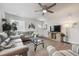 Comfortable living room with a ceiling fan and a large television, creating a relaxing atmosphere at 22 S Harlan St, Lakewood, CO 80226
