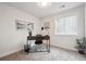 A neat office space featuring gray carpet, a modern desk, and natural light from the window at 22 S Harlan St, Lakewood, CO 80226