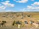 Expansive aerial view of a large home and property showcasing the surrounding landscape and neighborhood at 56330 E 37Th Ct, Strasburg, CO 80136