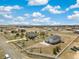 A beautiful aerial view of a home, large lot, a storage building, and white fencing at 56330 E 37Th Ct, Strasburg, CO 80136