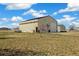 Large barn with roll-up doors and ample space for storage or workshop use on a well-maintained lot at 56330 E 37Th Ct, Strasburg, CO 80136