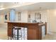 Finished basement with kitchenette, bar stool seating and glass brick accents at 56330 E 37Th Ct, Strasburg, CO 80136