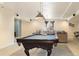 Pool table inside finished basement with lounge area and soft lighting at 56330 E 37Th Ct, Strasburg, CO 80136