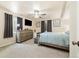 This main bedroom features neutral walls, a ceiling fan, dresser and TV at 56330 E 37Th Ct, Strasburg, CO 80136