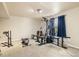 Carpeted exercise room featuring a weight machine, bench, and other exercise equipment at 56330 E 37Th Ct, Strasburg, CO 80136