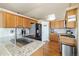 Bright kitchen offers stainless steel appliances, pantry, granite counters, and beautiful hardwood floors at 56330 E 37Th Ct, Strasburg, CO 80136