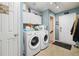 The laundry room has front loading washer/dryer combo with cabinet storage at 56330 E 37Th Ct, Strasburg, CO 80136