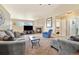 Spacious living room featuring comfortable seating, a fireplace, and large windows for an airy and inviting feel at 56330 E 37Th Ct, Strasburg, CO 80136