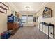 Cozy living room featuring carpeted floors and natural lighting from the large windows at 56330 E 37Th Ct, Strasburg, CO 80136