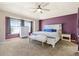 Spacious main bedroom with beautiful carpeting, a ceiling fan, and great natural light at 56330 E 37Th Ct, Strasburg, CO 80136