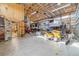 Spacious outbuilding filled with RV, lawn tractors, and storage featuring high ceilings at 56330 E 37Th Ct, Strasburg, CO 80136