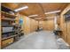 Interior of a spacious outbuilding featuring shelving, lighting, and concrete flooring at 56330 E 37Th Ct, Strasburg, CO 80136