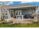 Back patio with a hot tub, fire pit, barbecue, and views of the backyard at 56330 E 37Th Ct, Strasburg, CO 80136