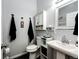 Well-lit bathroom with pedestal sink, storage cabinet, and sleek fixtures at 43388 Somerset Ct, Elizabeth, CO 80107