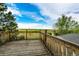 Relaxing wooden deck with a wood railing that showcases the beautiful views of the surrounding green landscape and blue skies at 43388 Somerset Ct, Elizabeth, CO 80107