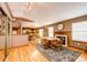 Cozy dining area with fireplace and wood floors adjacent to the open kitchen at 43388 Somerset Ct, Elizabeth, CO 80107