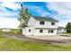 An open backyard featuring a two-story white home and an outbuilding at 43388 Somerset Ct, Elizabeth, CO 80107