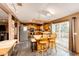 Charming kitchen with wooden cabinets, stainless steel appliances, a center island with seating, and a sliding glass door to deck at 43388 Somerset Ct, Elizabeth, CO 80107
