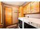 Functional laundry room with washer, dryer, and ample cabinet storage at 43388 Somerset Ct, Elizabeth, CO 80107