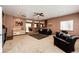 Open living room with wet bar, plush seating, and seamless flow to other living spaces at 43388 Somerset Ct, Elizabeth, CO 80107