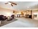 Spacious living room and kitchen combo boasts ample seating, carpet flooring, and a breakfast bar at 43388 Somerset Ct, Elizabeth, CO 80107