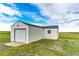 Exterior view of an outbuilding with a garage door and a small window at 43388 Somerset Ct, Elizabeth, CO 80107