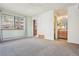 Spacious bedroom with carpet flooring, leading to bathroom and sunroom at 534 E 7Th Ave # 107, Denver, CO 80203